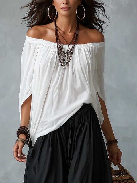 White off-shoulder top and flared lantern-style trousers