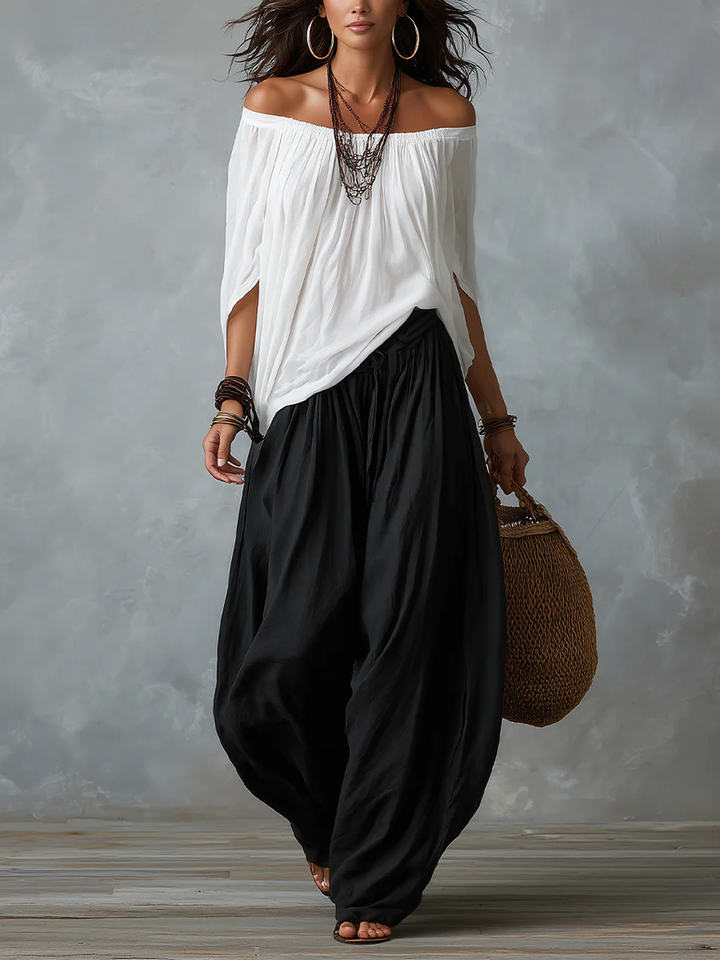 White off-shoulder top and flared lantern-style trousers