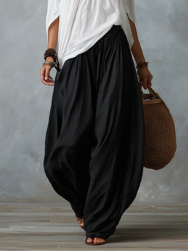 White off-shoulder top and flared lantern-style trousers