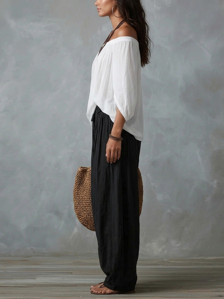 White off-shoulder top and flared lantern-style trousers